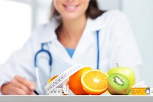 Nutritionist female Doctor in her office. Focus on fruit